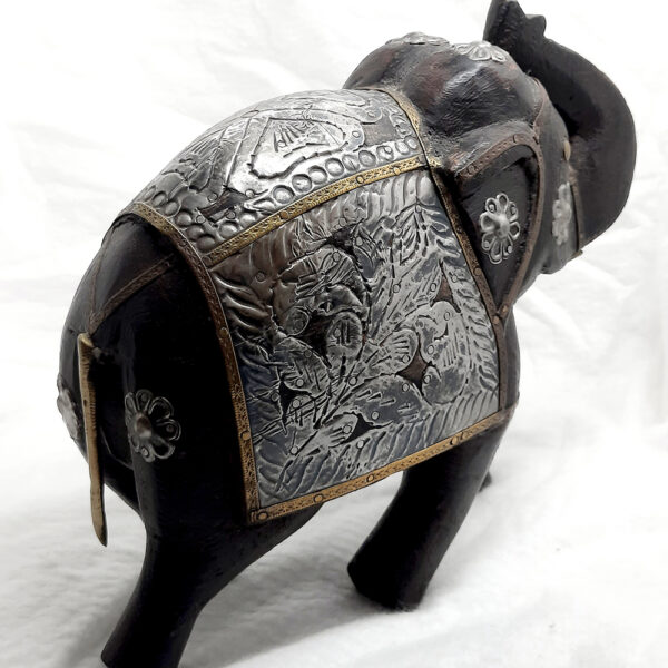 hand sculptured wooden elephant with metal embellishments