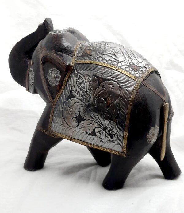 hand sculptured wooden elephant with metal embellishments