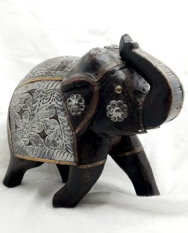 hand sculptured wooden elephant with metal embellishments