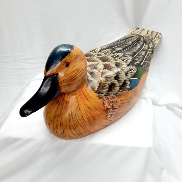 large tan coloured wooden decoy duck