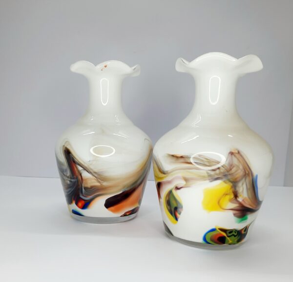 pair of white vases with multi coloured swirl pattern