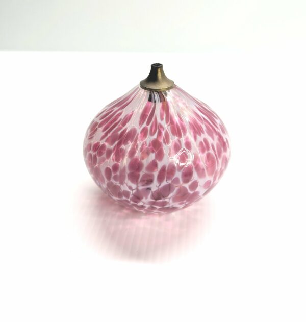 pink and white glass oil burner